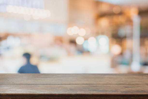 istock Wood table top and blurred restaurant interior background 662985330