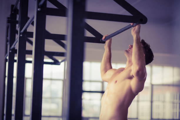 istock Muscular man lifting himself up and down 662985434