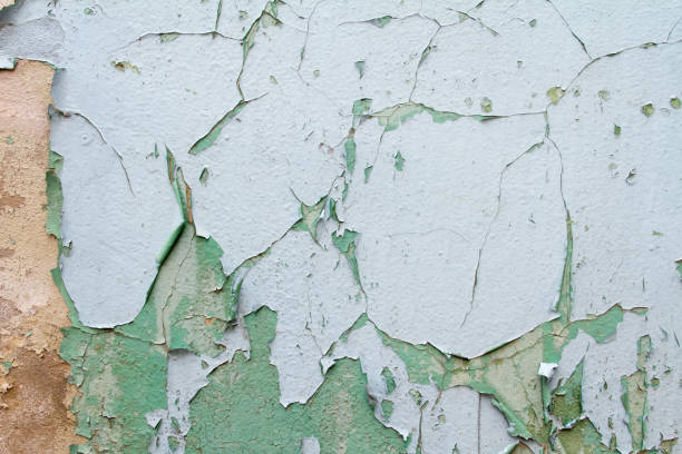 istock Vintage background texture of old brick masonry on ancient cement with cracks with traces of old paint. 662997172
