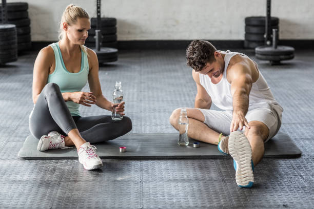 istock Sports couple stretching and drinking water 663003576