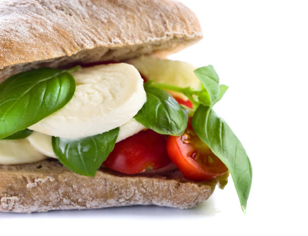 istock Ciabatta with mozzarella, tomato and basil isolated on white 663013510