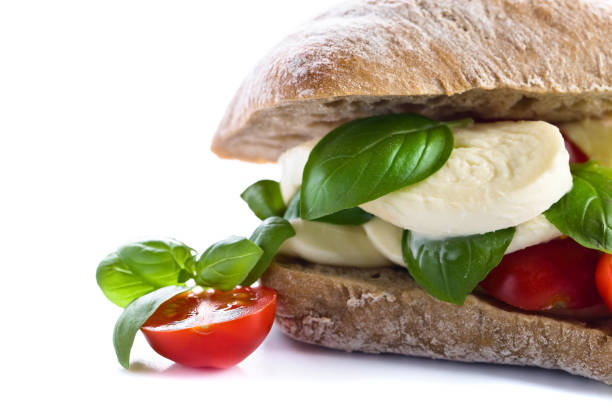 istock Ciabatta with mozzarella, tomato and basil isolated on white 663013984