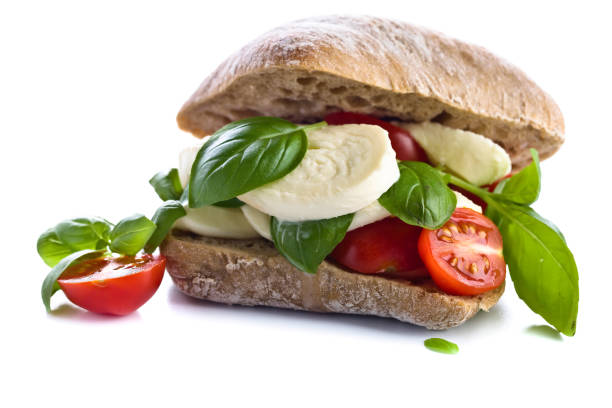 istock Ciabatta with mozzarella, tomato and basil isolated on white 663014194