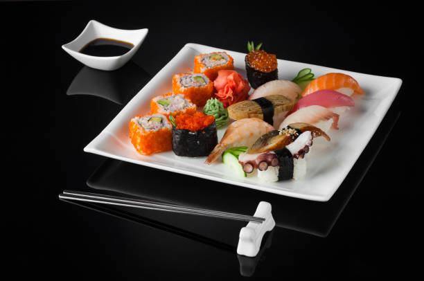 istock sushi in a plate on a black background 663023202