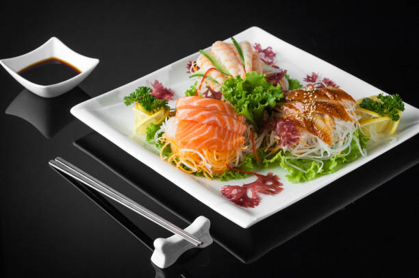 istock sushi in a plate on a black background 663028968