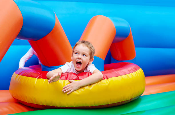 istock happy excited boy having fun on inflatable attraction playground 663031178
