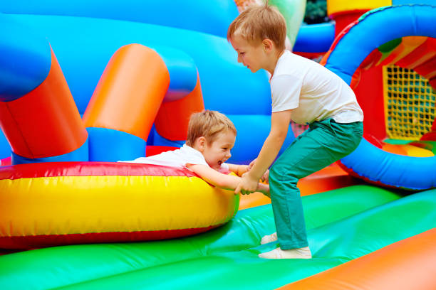 istock excited kids having fun on inflatable attraction playground 663031388