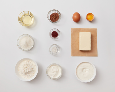 Top view of different ingredients for baking or cooking represented separately over white background. Ingredients for cooking cakes or breads.