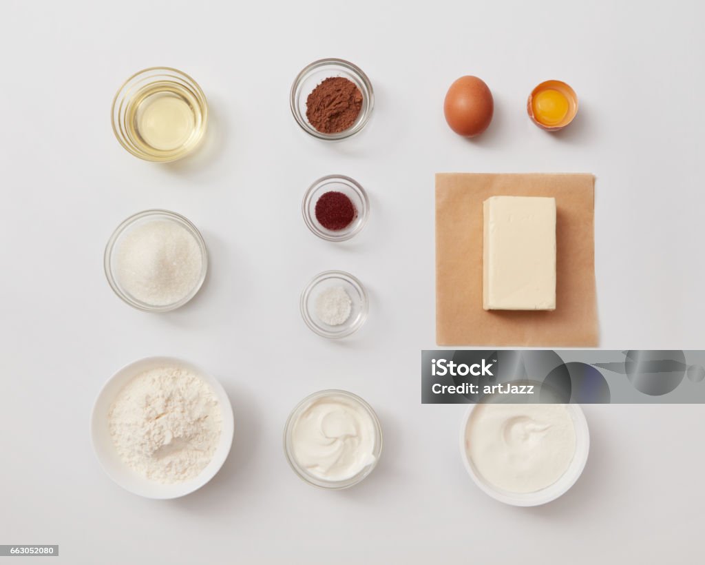 Ingredients for baking or cooking Top view of different ingredients for baking or cooking represented separately over white background. Ingredients for cooking cakes or breads. Top - Garment Stock Photo