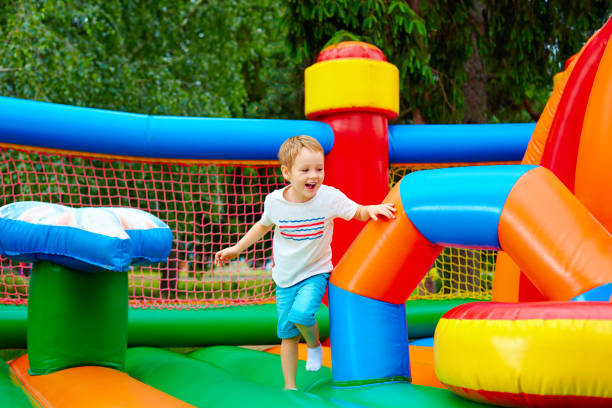 istock happy excited boy having fun on inflatable attraction playground 663063298