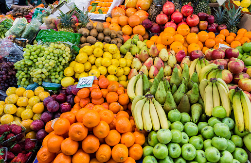 A wide variety of fruits in trays on the market.