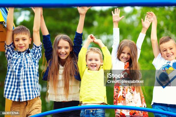 Happy Excited Kids Having Fun Together On Playground Stock Photo - Download Image Now