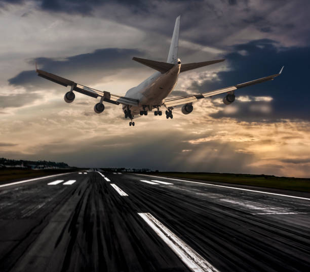 istock Jumbo Jet airplane landing at dusk 663075338