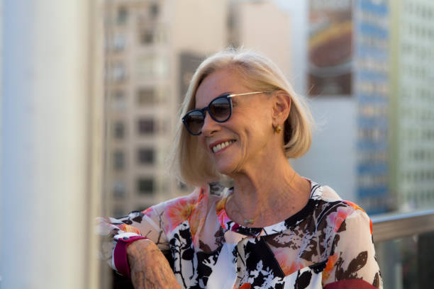Senior woman laughing with buildings at the background