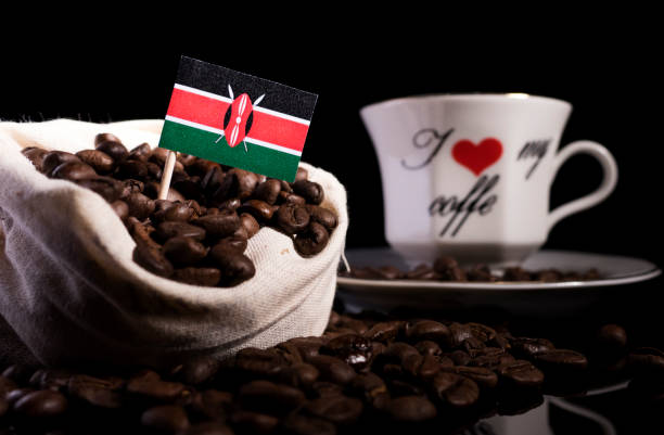 Kenyan flag in a bag with coffee beans isolated on black background stock photo