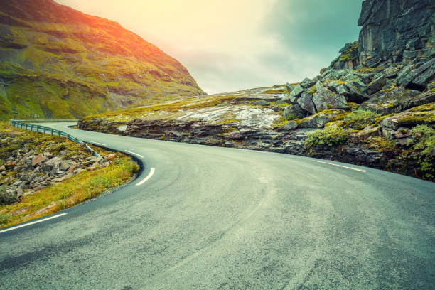 istock Driving a car on mountain road. Road among mountains 663086296
