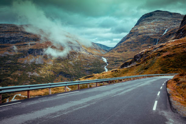 istock Driving a car on mountain road. Road among mountains 663096698