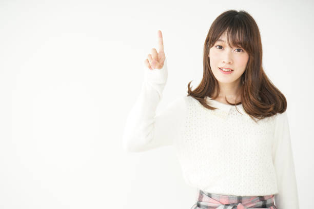 istock Young woman pointing something with smile 663098632