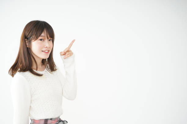 istock Young woman pointing something with smile 663100644