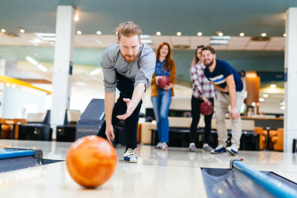 istock Friends having fun while bowling and speding time together 663104486