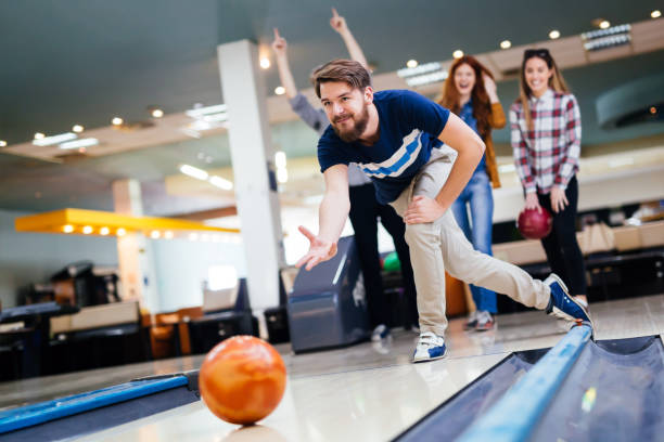 istock Friends having fun while bowling and speding time together 663104916