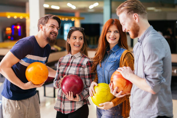 istock Friends having fun while bowling and speding time together 663106928