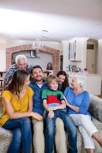 istock Multi-generation family sitting together on sofa 663114996
