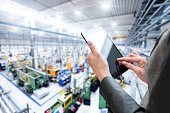 Female manager & tablet in new factory