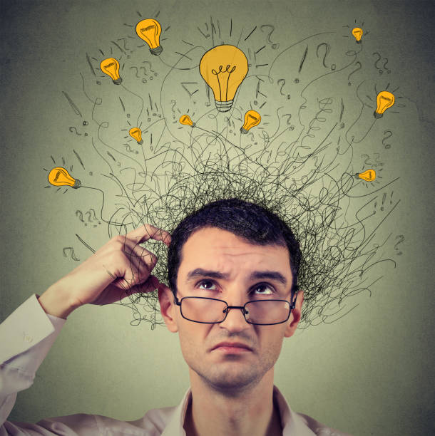 istock Thinking man with question signs and light idea bulbs above head 663126378