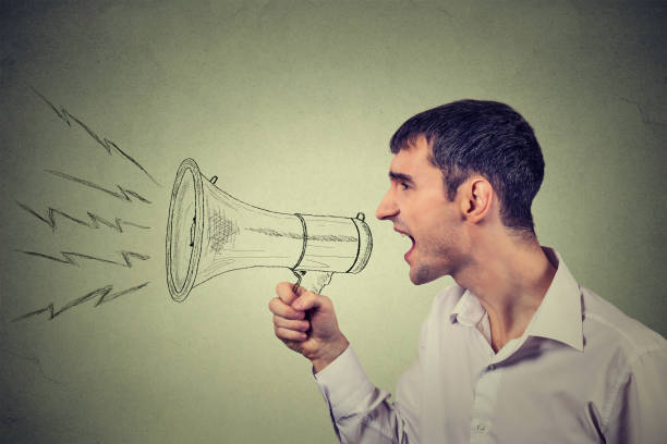 istock Side profile business man shouting into a megaphone 663127860