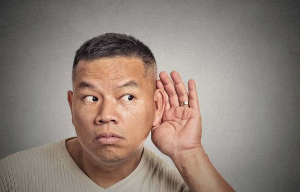 istock curious middle ged man listening to conversation 663147466