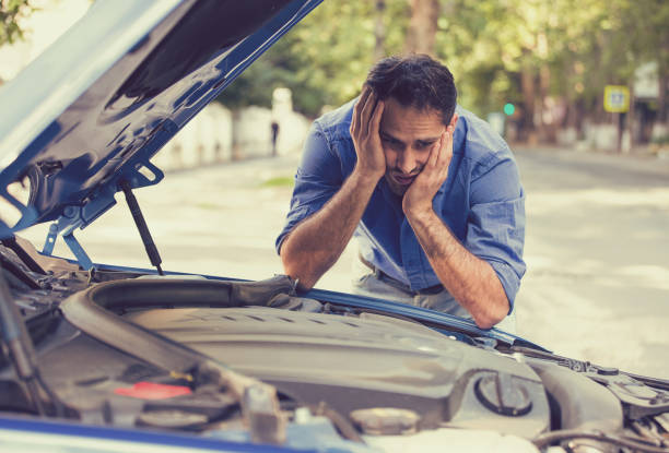 young stressed man having trouble with his broken car stock photo