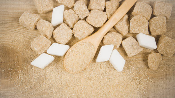 istock Cubes of sugar - brown sugar cane. 663164286