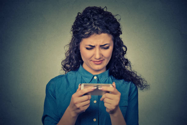 istock upset sad skeptical unhappy serious woman talking texting on phone 663181496