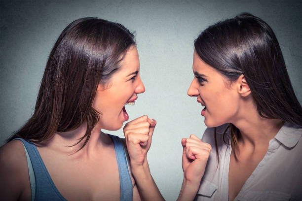 istock Angry girls looking at each other 663190614