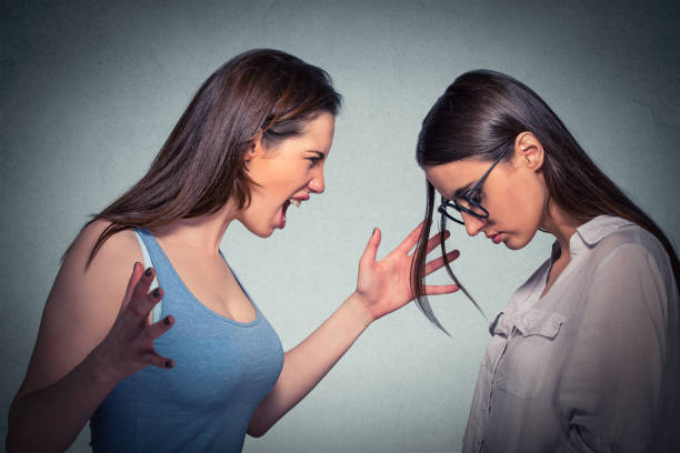 istock Young angry woman abusing screaming at another 663190634