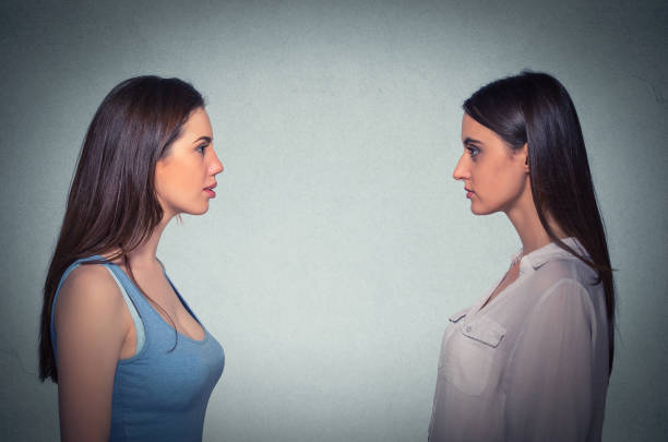 istock Side profile two young women looking at each other 663190938