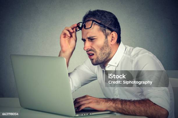 Business Man With Glasses Having Eyesight Problems Stock Photo - Download Image Now - Confusion, Men, Desktop PC