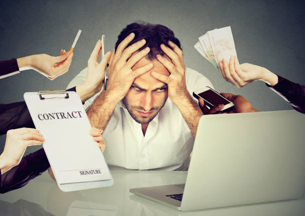 istock Stressed young man sitting at his desk in front of computer 663198152