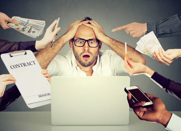 istock Stressed young man sitting at his desk in front of computer 663198164