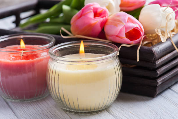 Yellow and pink aroma candles with tulips