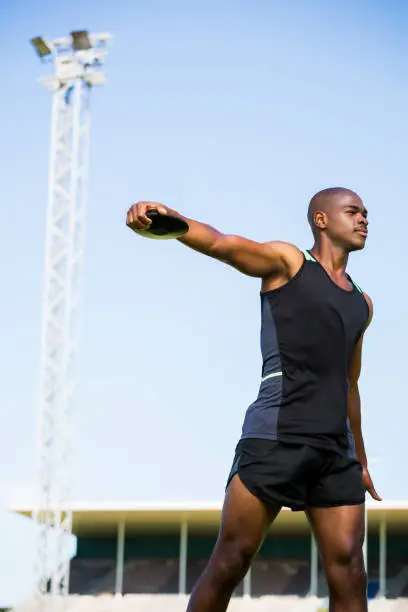 Athlete about to throw a discus in stadium