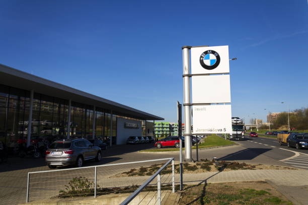 BMW car company logo in front of dealership building Prague, Czech republic - February 31, 2017: BMW car company logo in front of dealership building on March 31, 2017 in Prague, Czech republic. UK BMW workers back strike over pensions. bmw dealership stock pictures, royalty-free photos & images