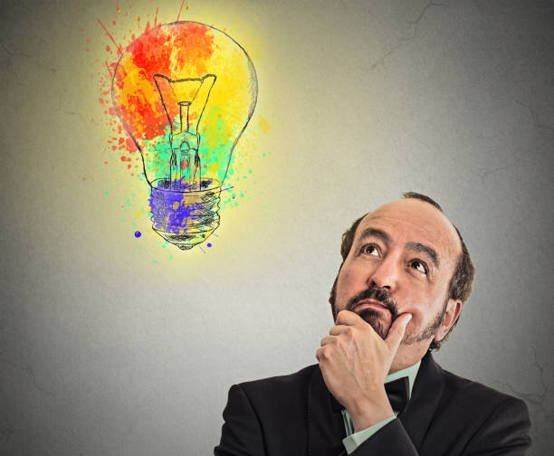 istock Middle aged business man with thoughtful expression and light bulb 663219540