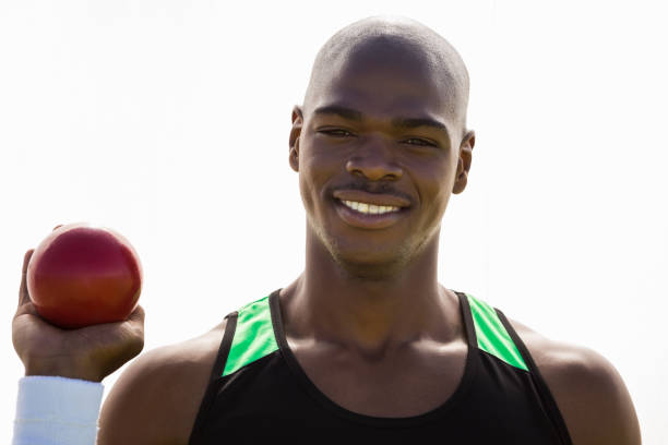istock Male athlete holding shot put ball 663225526