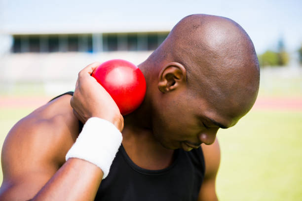 istock Male athlete holding shot put ball 663227874