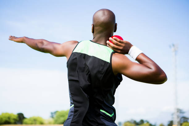 Male athlete preparing to throw shot put ball