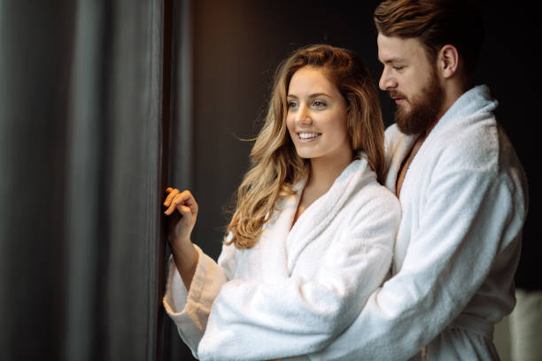 istock Couple in bathrobes enjoying wellness weekend 663246302