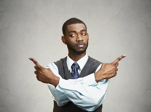 istock confused young business man pointing in two different directions 663247570