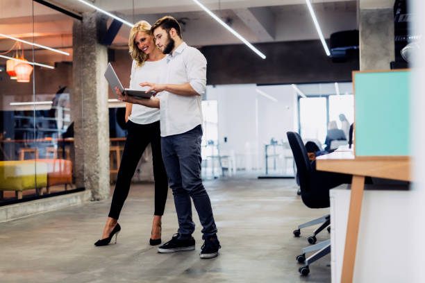 istock Discussing new ideas with a coworker in a beautiful modern office 663261816